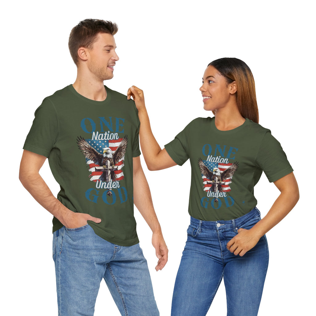 Couple wearing Military Green One Nation Under God - Eagle - T-shirts. Wear your faith and patriotism boldly with our "One Nation Under God" patriotic T-shirt. It features a striking design of an American Bald Eagle, a Cross, and the iconic American flag.