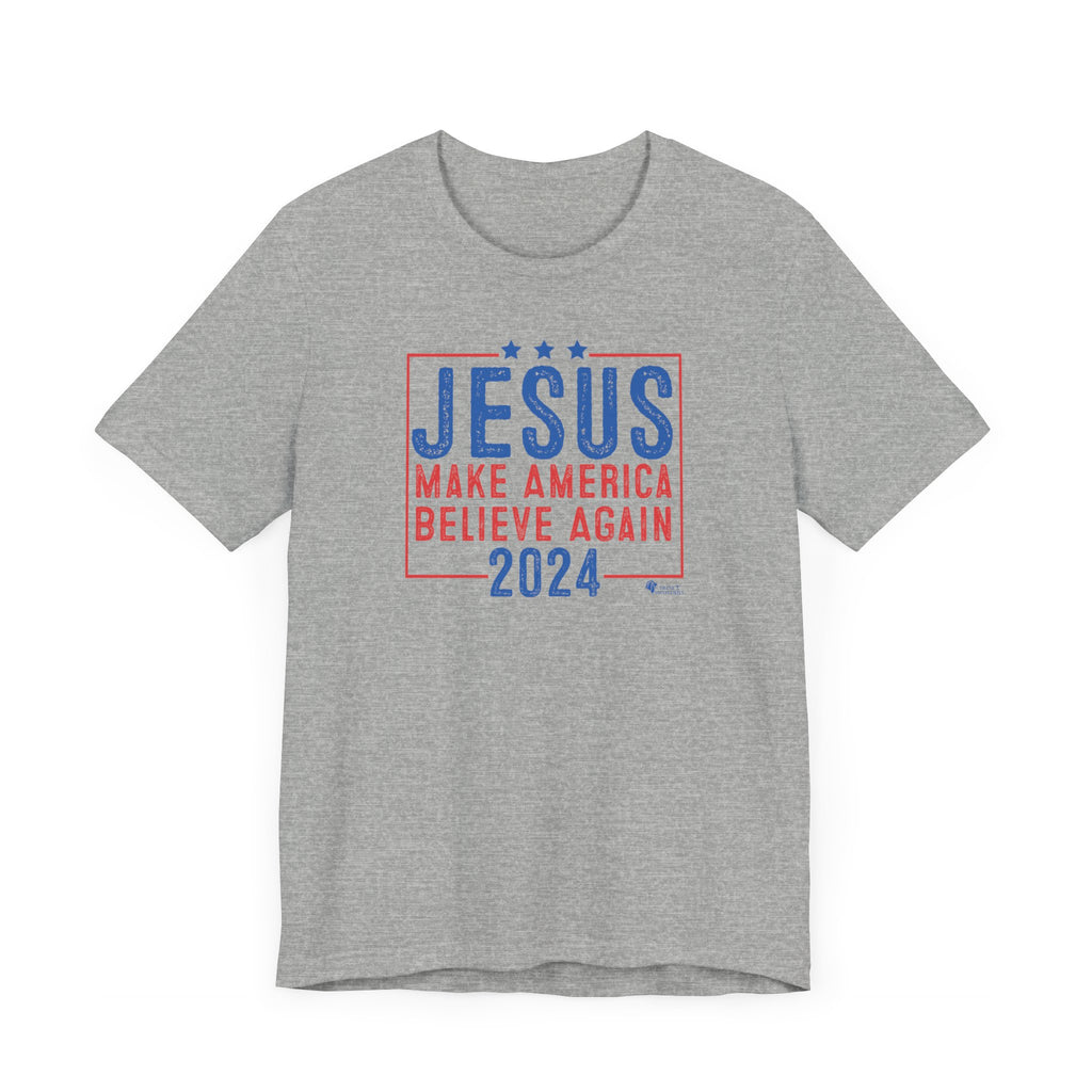 A gray Jesus 2024 - Make America Believe Again T-shirt by Trini-T Ministries. Embrace your faith and share a powerful message with our "Jesus 2024 - Make America Believe Again" unisex t-shirt. Designed for Christians who put Jesus above politics and candidates, recognizing Him as our true Savior. This tee blends a playful spoof of political campaigns with a unifying call to believe in Him.