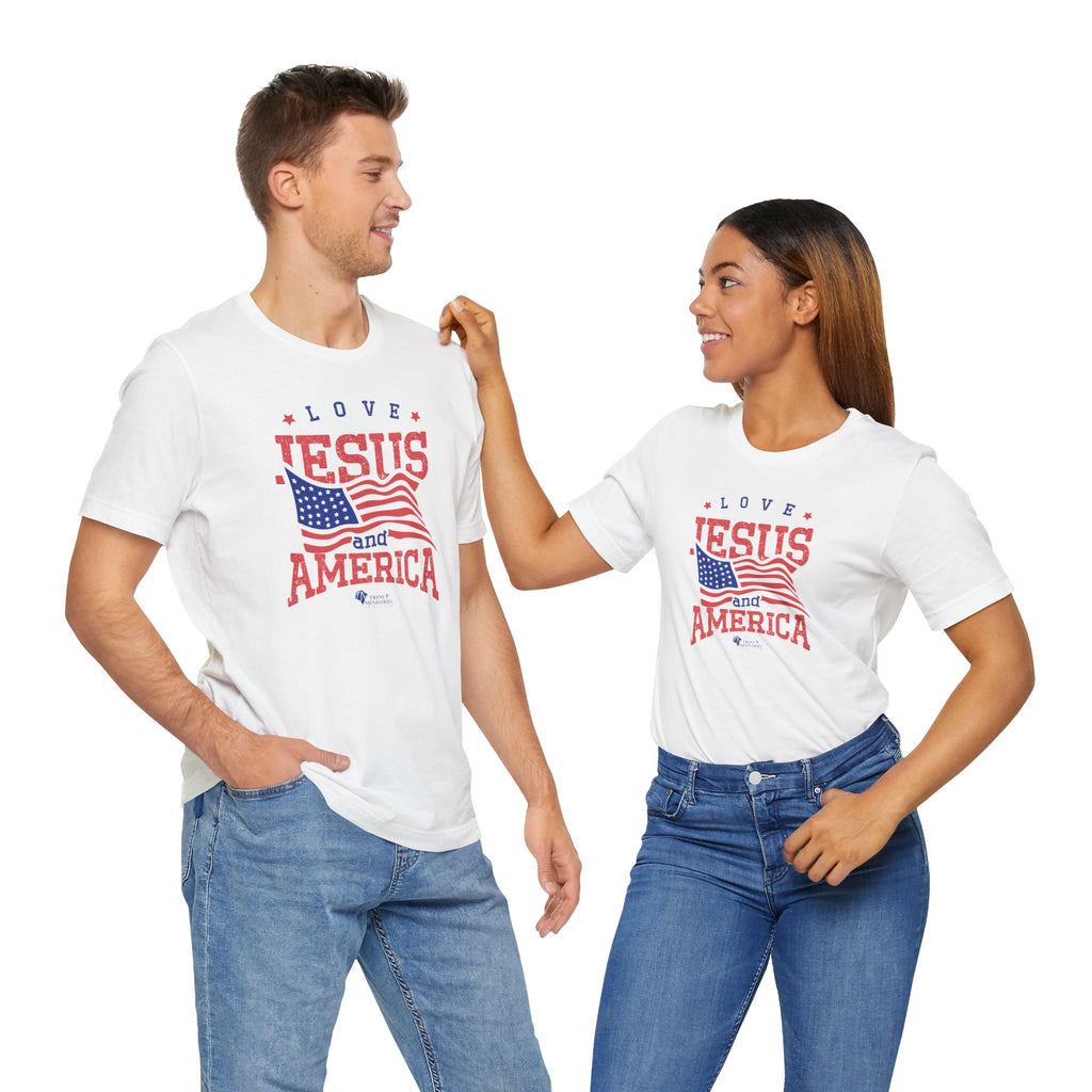 A couple in the Studio wearing white Bella + Canvas 3001 t-shirts with Trini-T Ministries' Love Jesus and America design. Celebrate your faith and patriotism with our "Love Jesus and America Too" Family T-Shirts. This inspirational graphic tee is perfect for Christians who want to share the Word of God and Jesus, while expressing their love for their country. Ideal for families who enjoy matching outfits during patriotic holidays and special events.