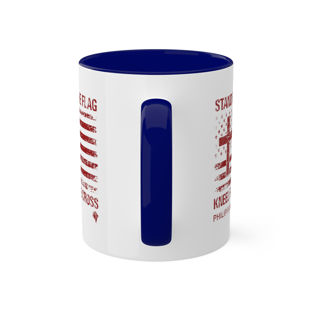 Kneel for the Cross blue accented mug from Trini-T Ministries with the handle on the front.  Celebrate your faith and patriotism with our "Kneel For The Cross" Patriotic Christian Mug. This 11oz ceramic coffee cup is perfect for Christians who love to share the Word of God, honor the cross, and express their love for their country. Featuring a bold and inspiring design, this mug is an excellent addition to your morning routine or quiet time.