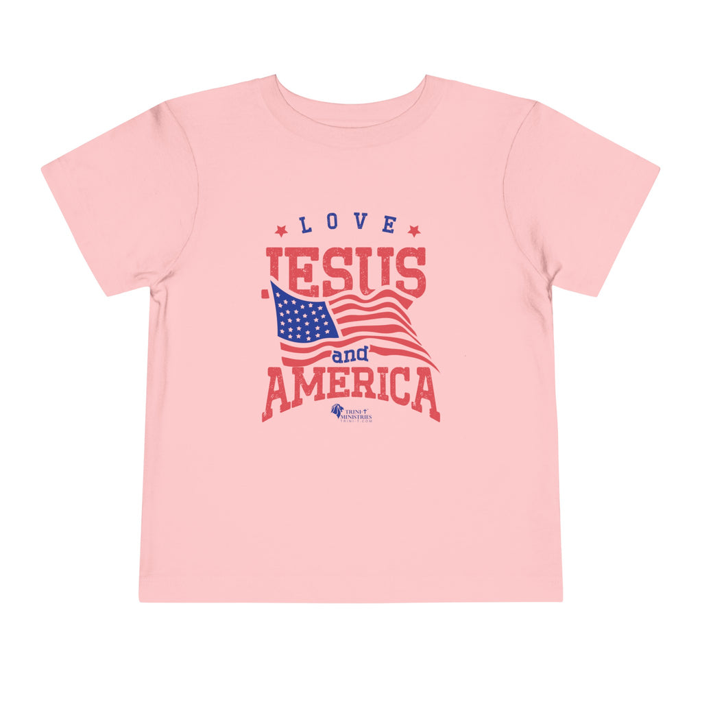 Pink Trini-T Ministries' Love Jesus and America Bella+Canvas 3001T shirt. Get our "Love Jesus and America" Toddler T-Shirt to let your toddler display their faith and patriotism. This delightful and motivating graphic tee is ideal for parents, relatives, and friends who wish to spread the Word of God and express their love for America through their toddler's clothing.