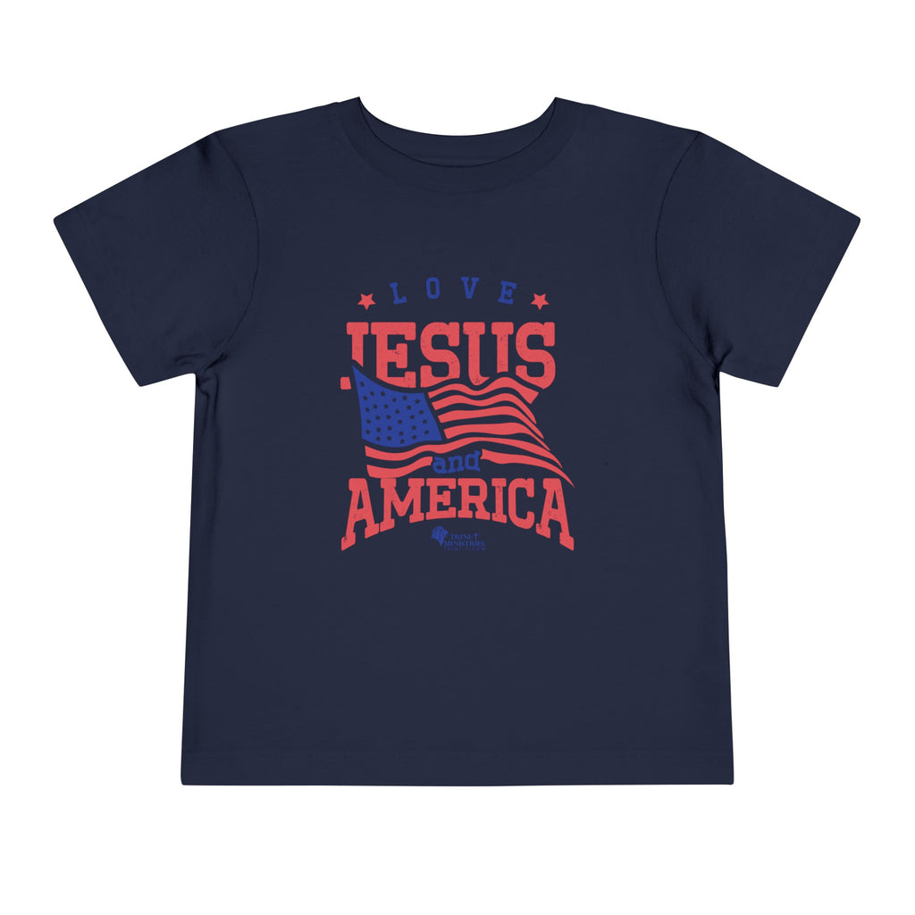 Navy blue Trini-T Ministries' Love Jesus and America Bella+Canvas 3001T shirt. Get our "Love Jesus and America" Toddler T-Shirt to let your toddler display their faith and patriotism. This delightful and motivating graphic tee is ideal for parents, relatives, and friends who wish to spread the Word of God and express their love for America through their toddler's clothing.