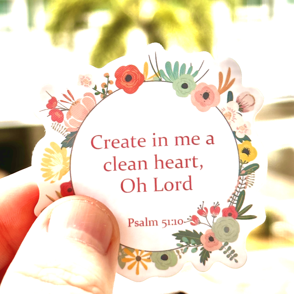 Christian sticker with the Bible verse Psalm 51:10 'Create in me a clean heart, Oh Lord' in a floral wreath design. Perfect for adding a touch of faith to your journal, laptop, or water bottle, this sticker inspires prayer and renewal.