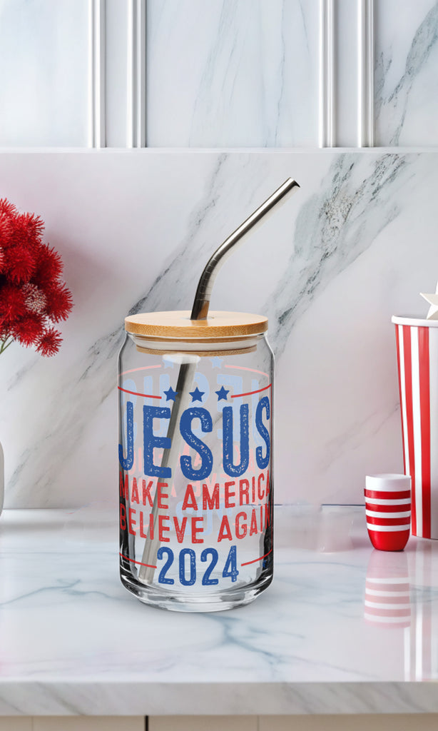Jesus 2024 - Make America Believe Again glass can with bamboo lid and reusable straw on a white marble kitchen counter.