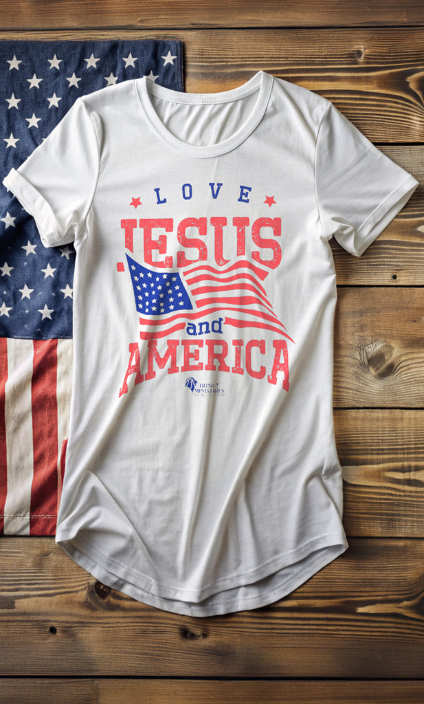 White Bella+Canvas 3006 Long Urban Tee with Trini-T Ministries Love Jesus and America design. USA flag and wooden planks. Elevate your streetwear game with our "Love Jesus and America" Long-body Urban Tee. This trendy graphic tee is designed for patriots who want to blend faith and fashion, and make a bold statement. Whether it’s for yourself or as a gift for a friend or family member, this shirt is ideal for showcasing your love for Jesus and America in a modern, urban style.