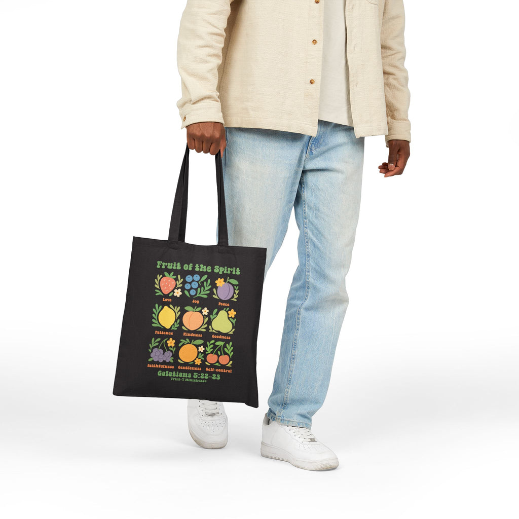 Man carrying black Fruit of the Spirit Tote Bag