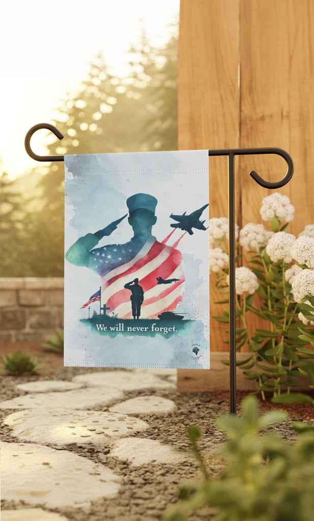 Trini-T Ministries We Will Never Forget Patriotic Memorial Garden Flag next to a garden pathway. It showcases a soldier saluting, the American flag waving proudly, a jet soaring in the sky, and a touching scene of a soldier visiting the graves of fallen comrades. This heartfelt design reflects the spirit of sacrifice and service, echoing the selflessness of Christ's sacrifice on the cross.