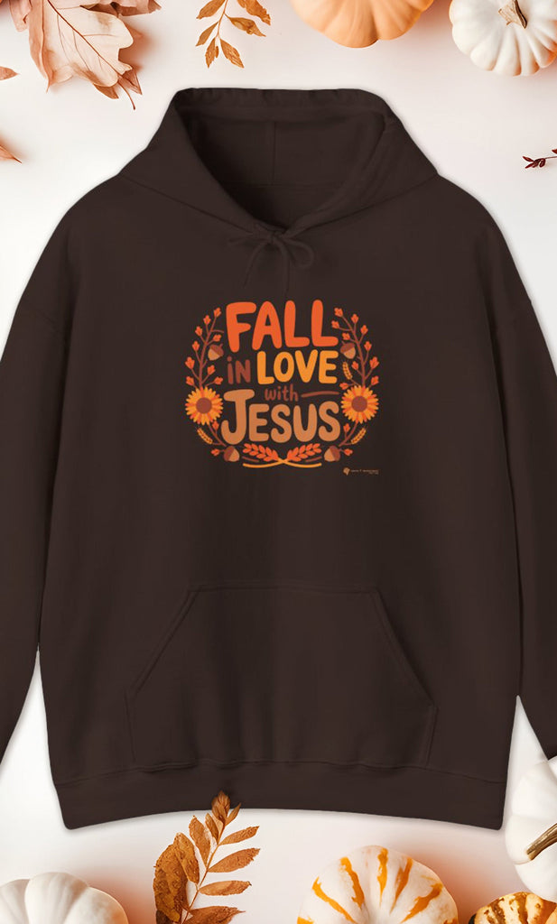 Brown Gildan 18500 'Fall in Love with Jesus' Hoodie surrounded by fall foliage and pumpkins, Christian autumn hoodie.