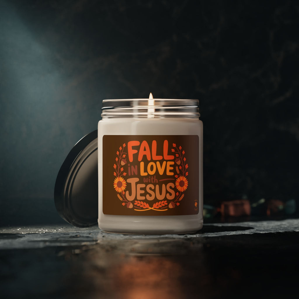 Fall in Love with Jesus soy candle glowing in a dark cozy setting, Christian fall decor with warm autumn ambiance.