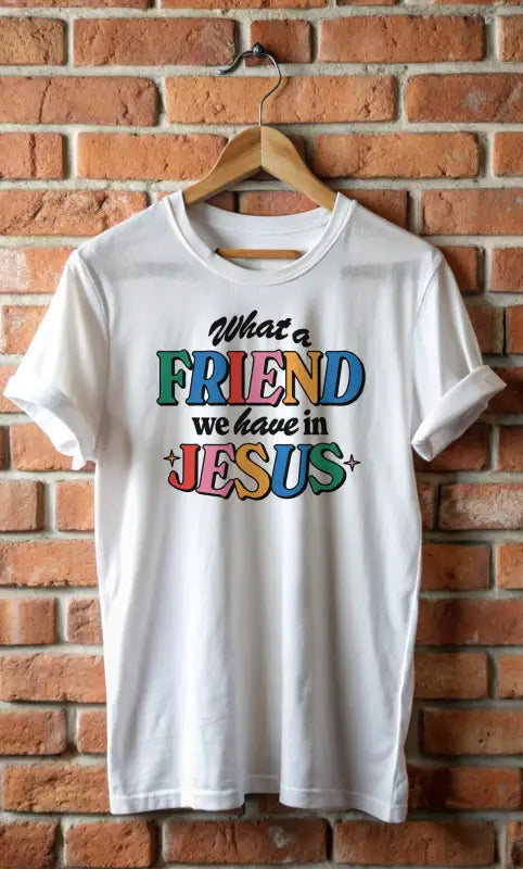 White kids’ t-shirt featuring colorful ’What a friend we have in Jesus’ text for active kids