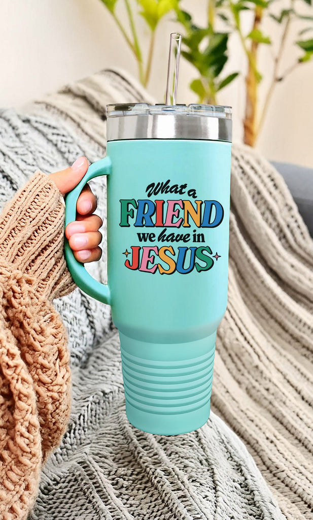 Turquoise 40oz insulated stainless steel tumbler with handle featuring the 'What a Friend We Have in Jesus' design. Perfect for keeping drinks hot or cold, this faith-inspired tumbler is an ideal companion for Christians on the go. Shown in a cozy setting, highlighting its comfort and style.