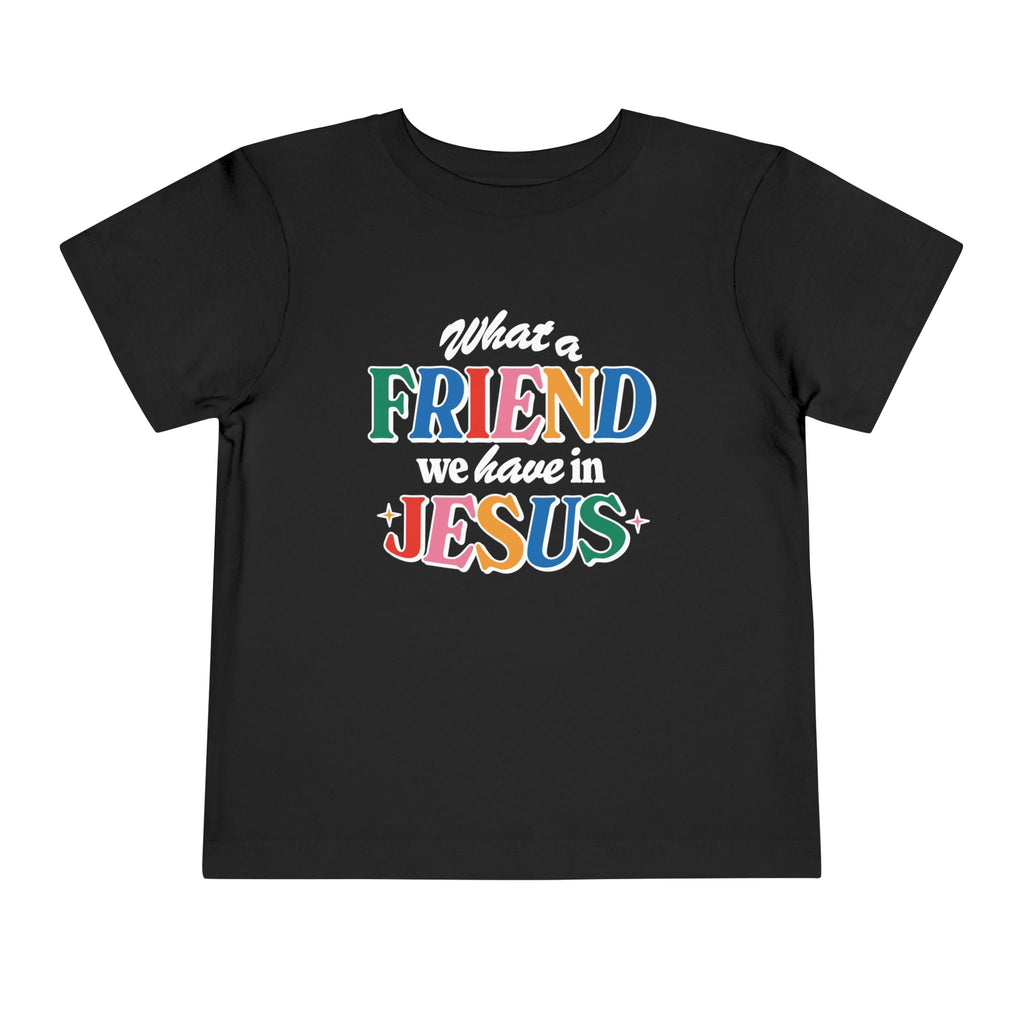 A black Friend in Jesus - Toddler T-shirt with vibrant, multi-colored text reading 'What a Friend we have in Jesus.' This Christian-themed shirt is perfect for little ones to boldly share their faith. Made from soft, breathable fabric, it’s ideal for daily wear or church. The John 15:15-inspired design serves as a sweet reminder of Jesus' friendship.