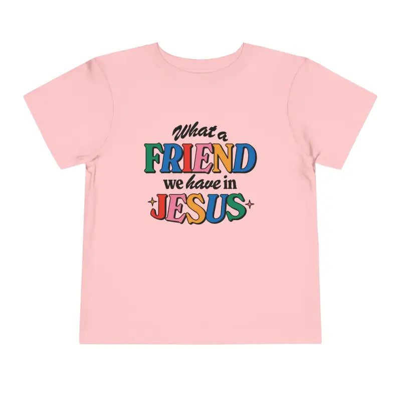 A pink Friend in Jesus - Toddler T-shirt with vibrant, multi-colored text reading 'What a Friend we have in Jesus.' This Christian-themed shirt is perfect for little ones to boldly share their faith. Made from soft, breathable fabric, it’s ideal for daily wear or church. The John 15:15-inspired design serves as a sweet reminder of Jesus' friendship.