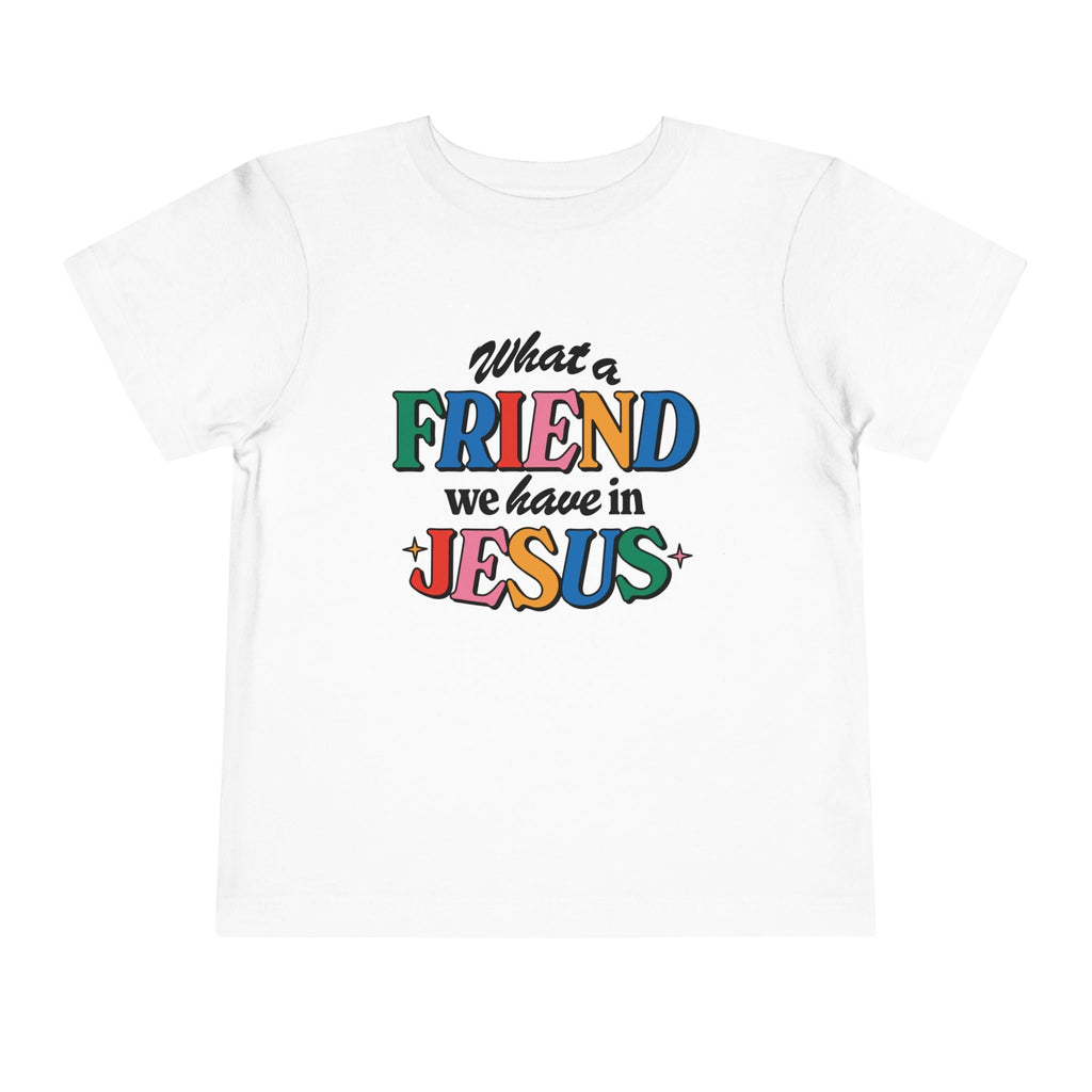 A white Friend in Jesus - Toddler T-shirt with vibrant, multi-colored text reading 'What a Friend we have in Jesus.' This Christian-themed shirt is perfect for little ones to boldly share their faith. Made from soft, breathable fabric, it’s ideal for daily wear or church. The John 15:15-inspired design serves as a sweet reminder of Jesus' friendship.