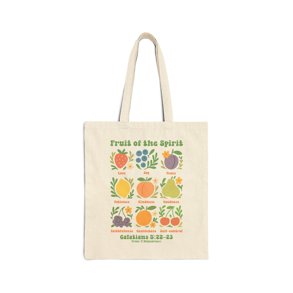 Flat lay of natural Fruit of the Spirit tote bag showing front design with Bible verse and fruit illustrations.