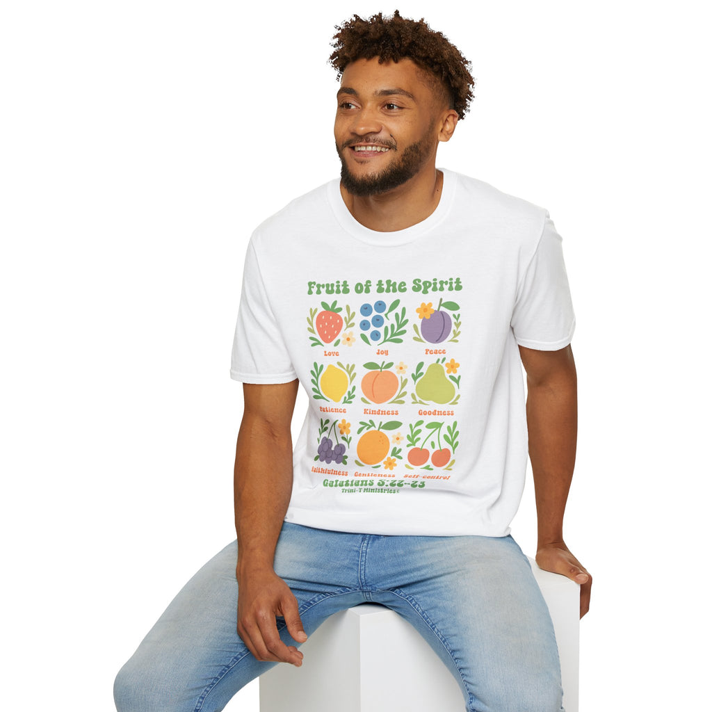 Smiling man seated, wearing white Fruit of the Spirit t-shirt featuring Galatians 5:22–23 design.