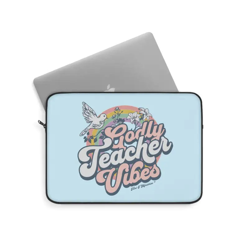 A flat lay view of the 12" Godly Teacher Vibes - Premium Laptop/Tablet Sleeve from Trini-T Ministries holding a Mac Book.