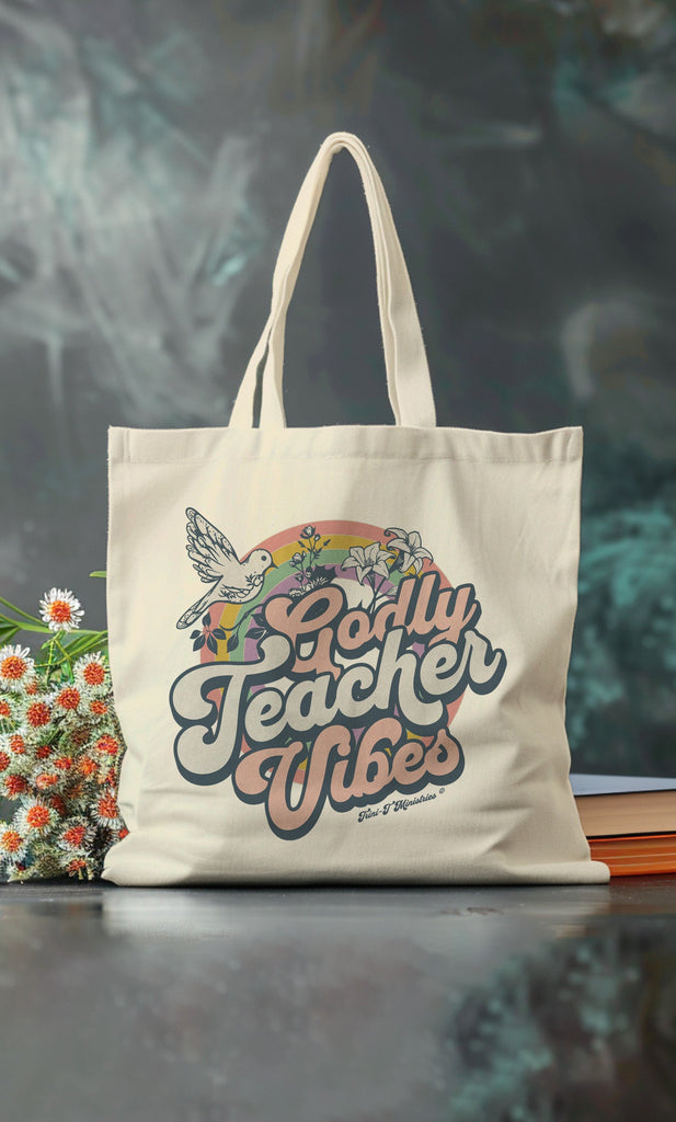 A studio shot of a natural colored Tote bag featuring the Godly Teacher Vibes from Trini-T Ministries.