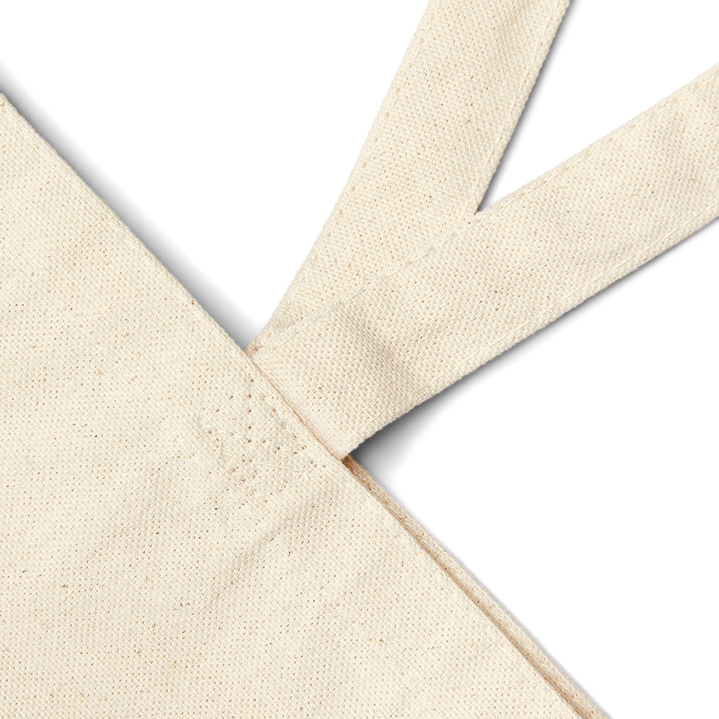 A close up of the natural colored tote bag straps.