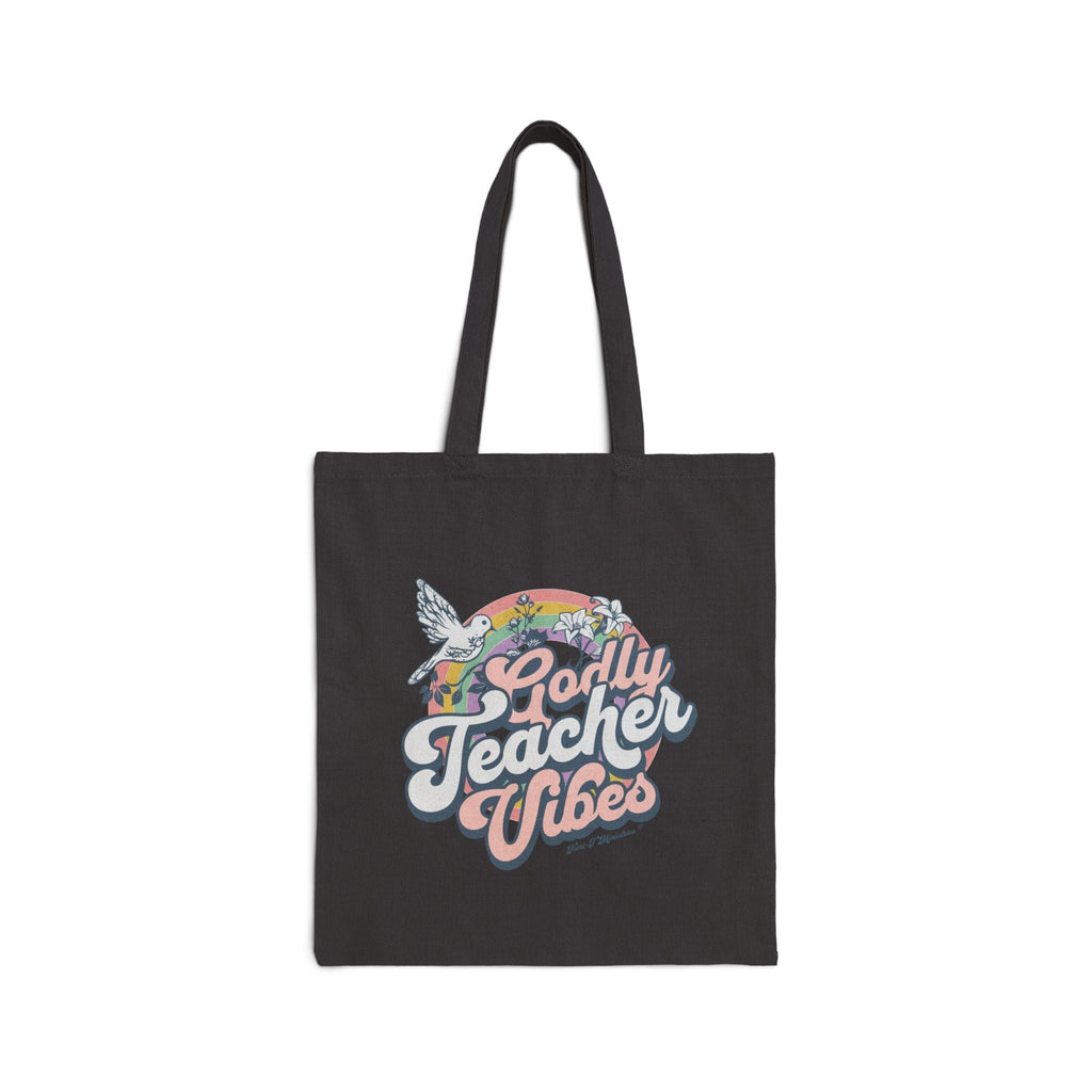 A studio shot of a black Tote bag featuring the Godly Teacher Vibes from Trini-T Ministries.