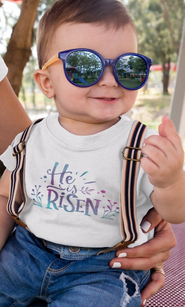 He Is Risen - Baby’s T -  Black / 6-12m, Black / 12-18m, Black / 18-24m, Pink / 6-12m, Pink / 12-18m, Pink / 18-24m, White / 6-12m, White / 12-18m, White / 18-24m -  Trini-T Ministries