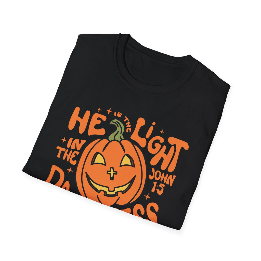 Detailed close-up of the "He is the Light" pumpkin design on a black t-shirt, perfect for sharing Christ’s message during Halloween.