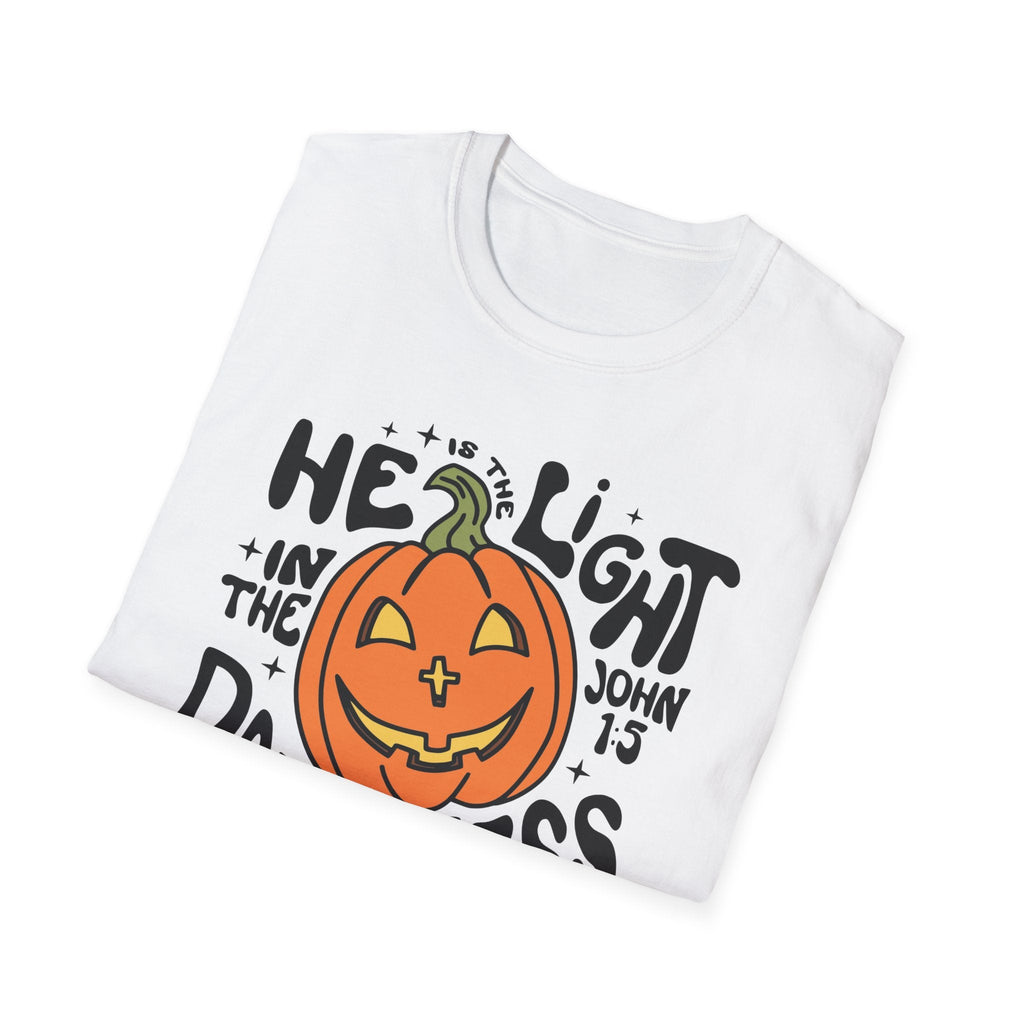 Front view of the "He is the Light" t-shirt in white, folded neatly, showcasing the bold pumpkin design and Christian message for Halloween.