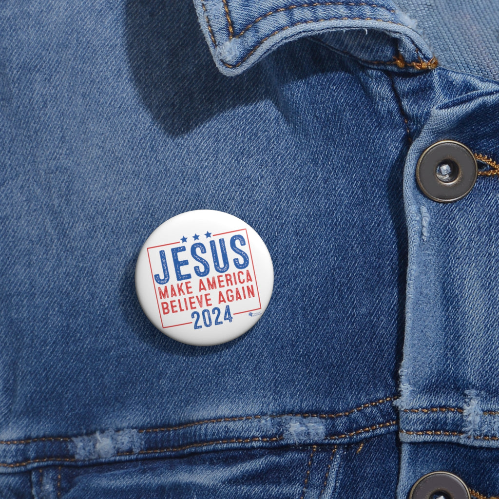 Small Christian 'Jesus 2024' campaign-style button worn on denim jacket lapel. Faith-inspired political parody pin in use.