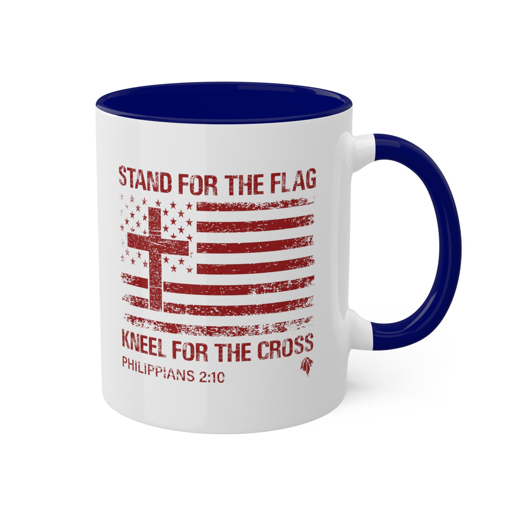 Kneel for the Cross blue accented mug from Trini-T Ministries with the handle on the right.  Celebrate your faith and patriotism with our "Kneel For The Cross" Patriotic Christian Mug. This 11oz ceramic coffee cup is perfect for Christians who love to share the Word of God, honor the cross, and express their love for their country. Featuring a bold and inspiring design, this mug is an excellent addition to your morning routine or quiet time.