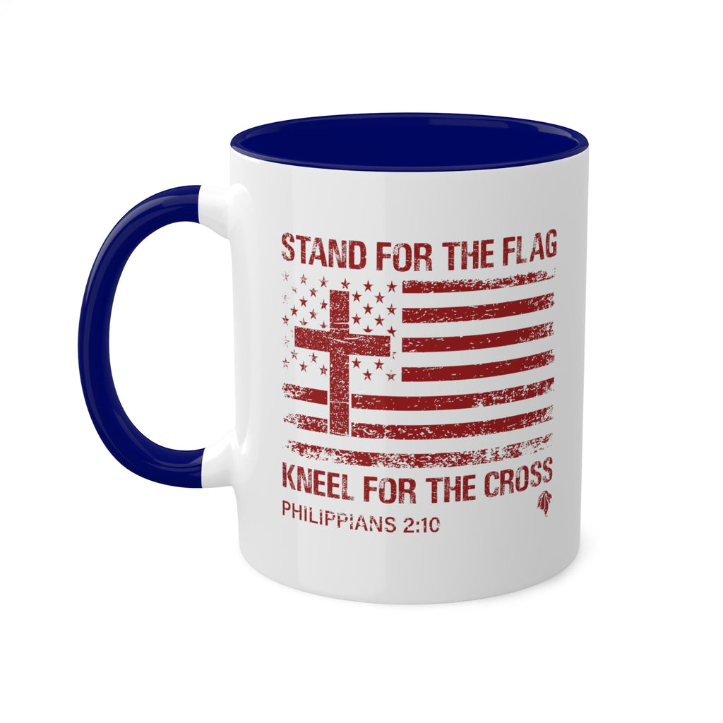 Kneel for the Cross blue accented mug from Trini-T Ministries with the handle on the left.  Celebrate your faith and patriotism with our "Kneel For The Cross" Patriotic Christian Mug. This 11oz ceramic coffee cup is perfect for Christians who love to share the Word of God, honor the cross, and express their love for their country. Featuring a bold and inspiring design, this mug is an excellent addition to your morning routine or quiet time.