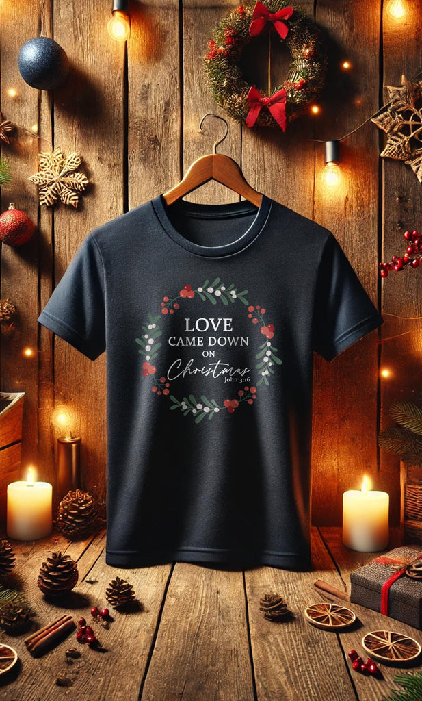 Love Came Down on Christmas John 3:16 Christian T-shirt in a cozy Christmas setting. Celebrate Jesus' birth with this Christmas gift worthy shirt