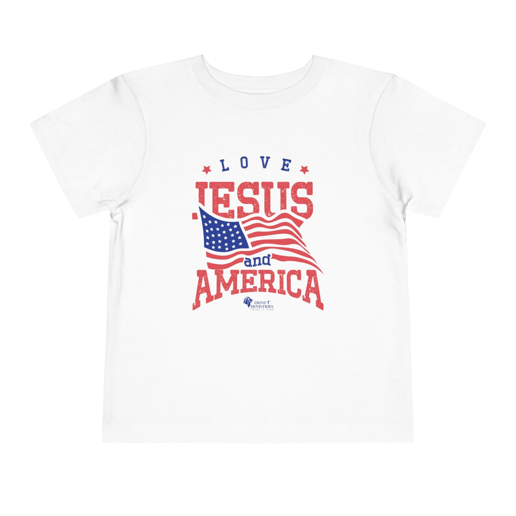 White Trini-T Ministries' Love Jesus and America Bella+Canvas 3001T shirt. Get our "Love Jesus and America" Toddler T-Shirt to let your toddler display their faith and patriotism. This delightful and motivating graphic tee is ideal for parents, relatives, and friends who wish to spread the Word of God and express their love for America through their toddler's clothing.