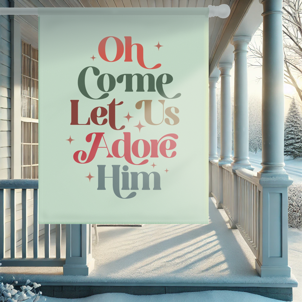 Oh Come Let Us Adore Him Christmas flag displayed in a snowy winter garden, celebrating the birth of Jesus.