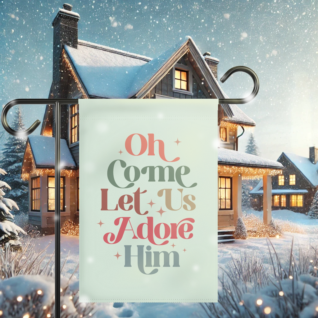 Oh Come Let Us Adore Him Christmas flag displayed in a snowy winter garden, celebrating the birth of Jesus.