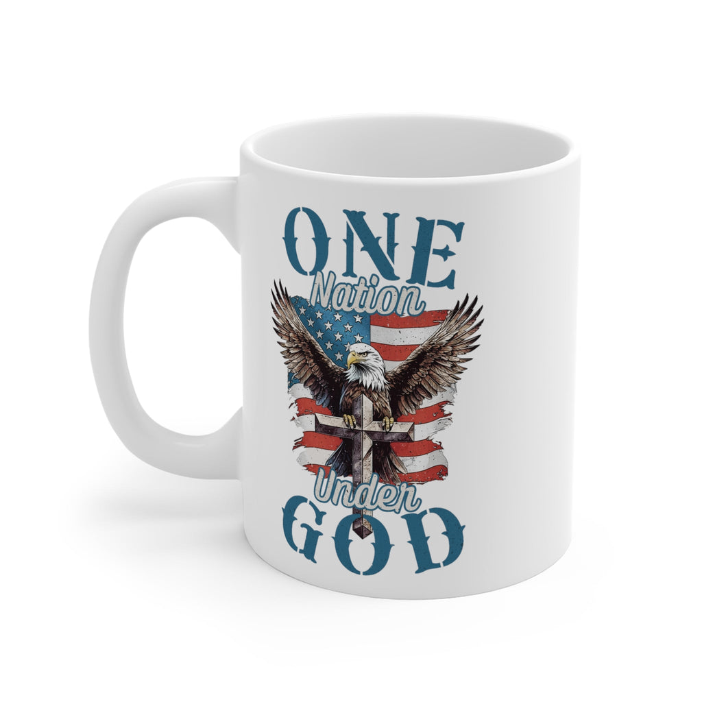 A white ceramic mug featuring Trini-T Ministries' One Nation Under God graphic. Enjoy your favorite hot beverage with a touch of faith and patriotism using our "One Nation Under God" patriotic ceramic mug. This classic white mug is perfect for coffee, tea, and hot chocolate enthusiasts. It features a striking design with an American Bald Eagle, a Cross, and the iconic American flag.