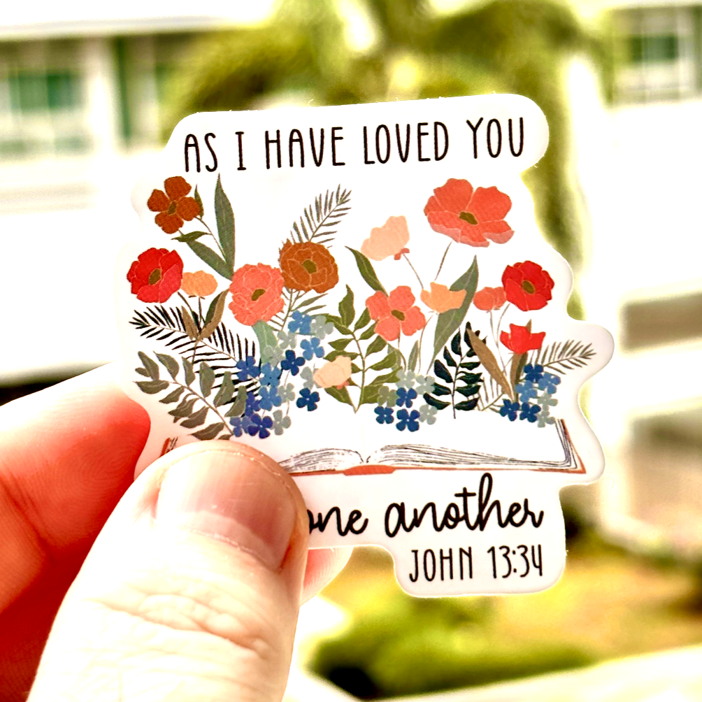 Inspirational sticker with the quote 'As I have loved you, love one another - John 13:34' surrounded by boho floral elements. Ideal for decorating planners, scrapbooks, and more, this sticker brings a message of love and positivity.